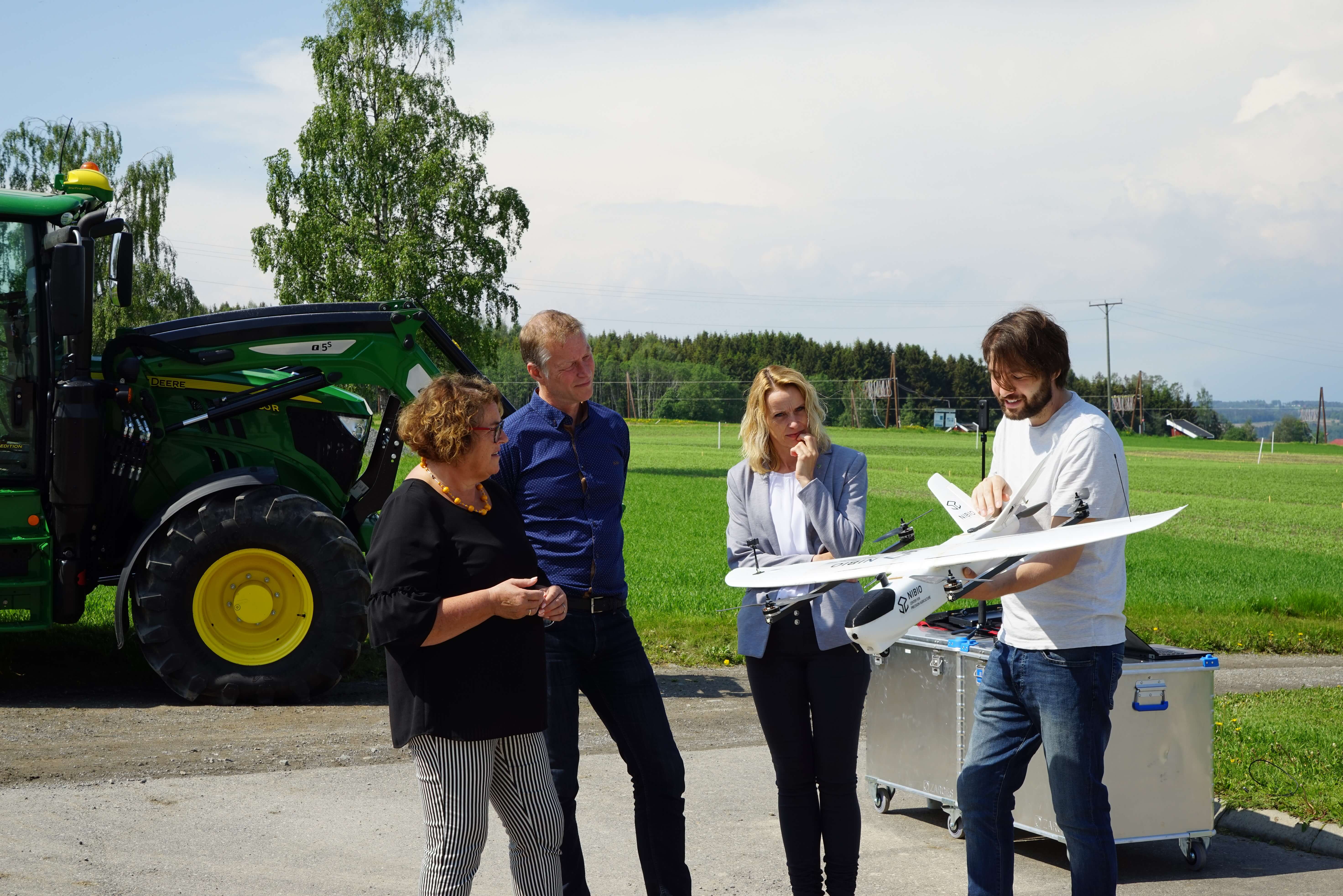 Max explains the advantages of a hybrid drone to the minister