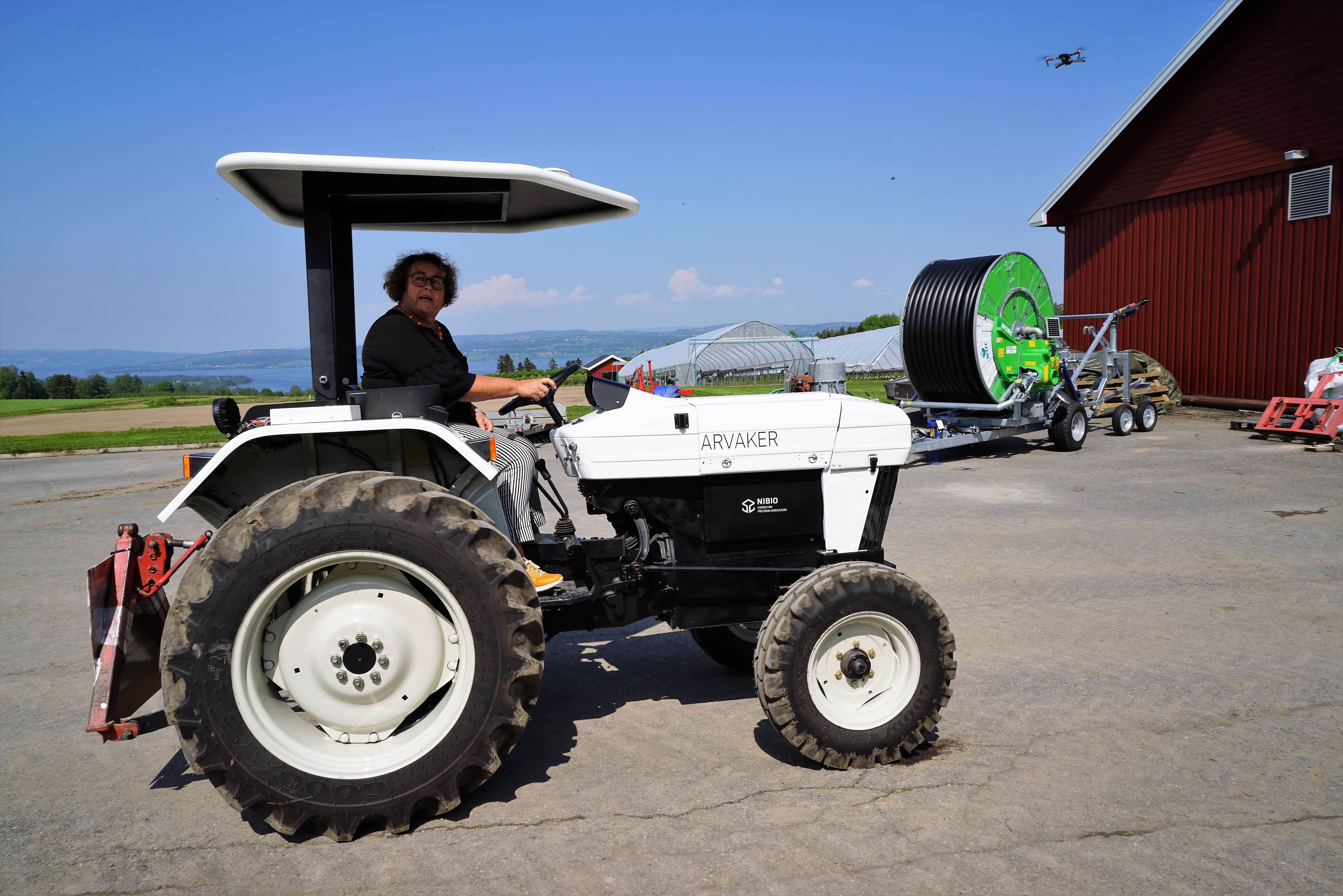 The minister tries out the new electrical tractor